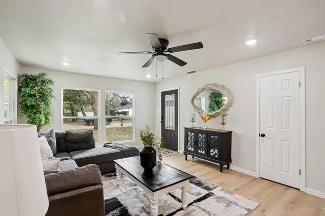 a living room with furniture a window and a fireplace