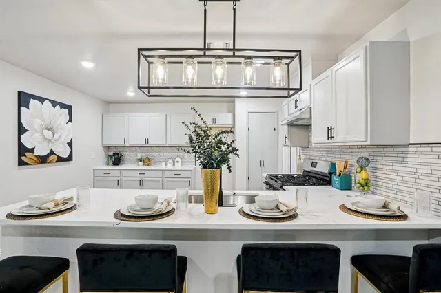 a kitchen with stainless steel appliances granite countertop a sink and stove