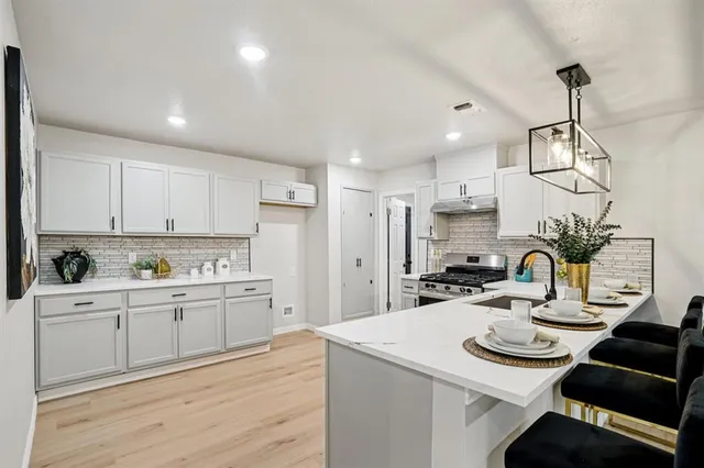a kitchen with stainless steel appliances kitchen island granite countertop a sink and cabinets