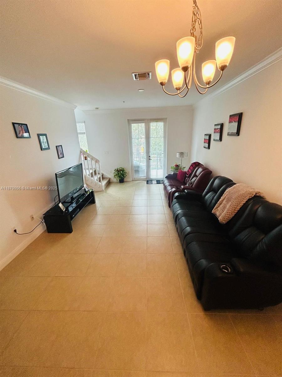 819 Southwest 147th Avenue, Unit 1405 Pembroke Pines, FL 33027 - Photo 12 of 31 a living room with furniture and a large window