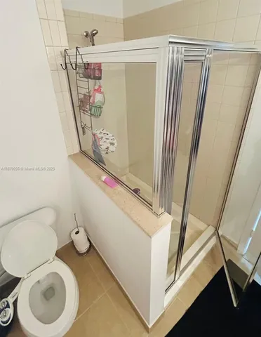 a bathroom with a toilet and a shower