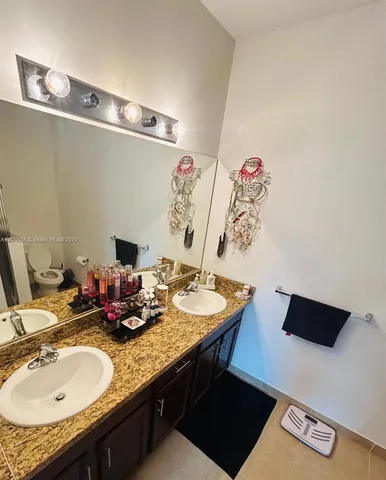a bathroom with a sink double vanity and a mirror