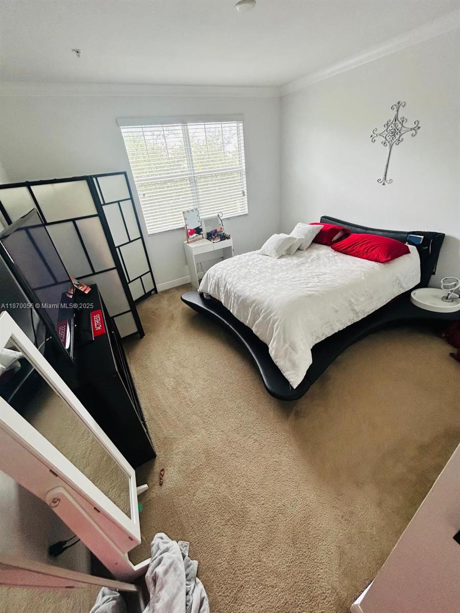 819 Southwest 147th Avenue, Unit 1405 Pembroke Pines, FL 33027 - Photo 19 of 31 a bedroom with a bed and window