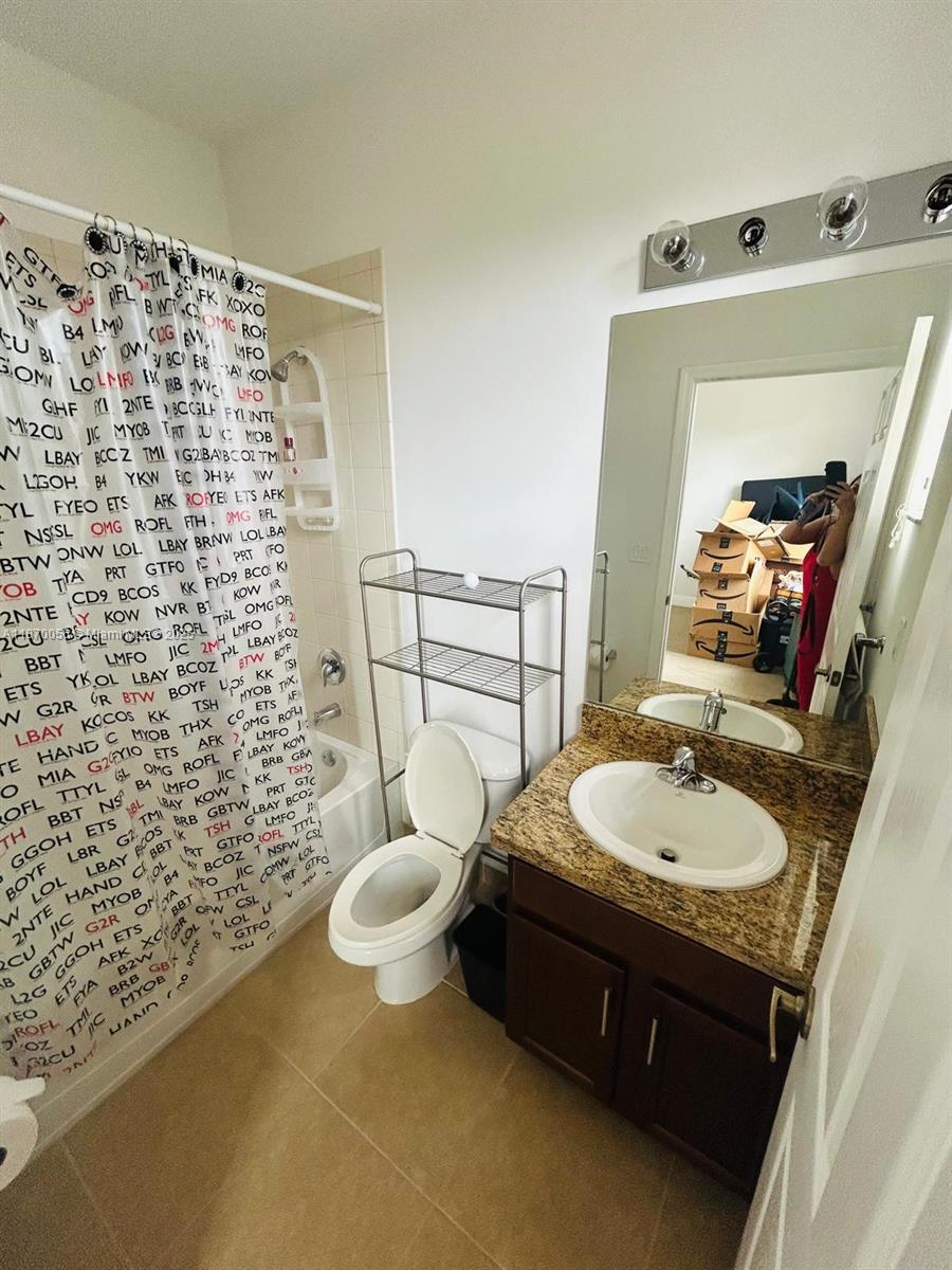 819 Southwest 147th Avenue, Unit 1405 Pembroke Pines, FL 33027 - Photo 21 of 31 a bathroom with a sink toilet and shower