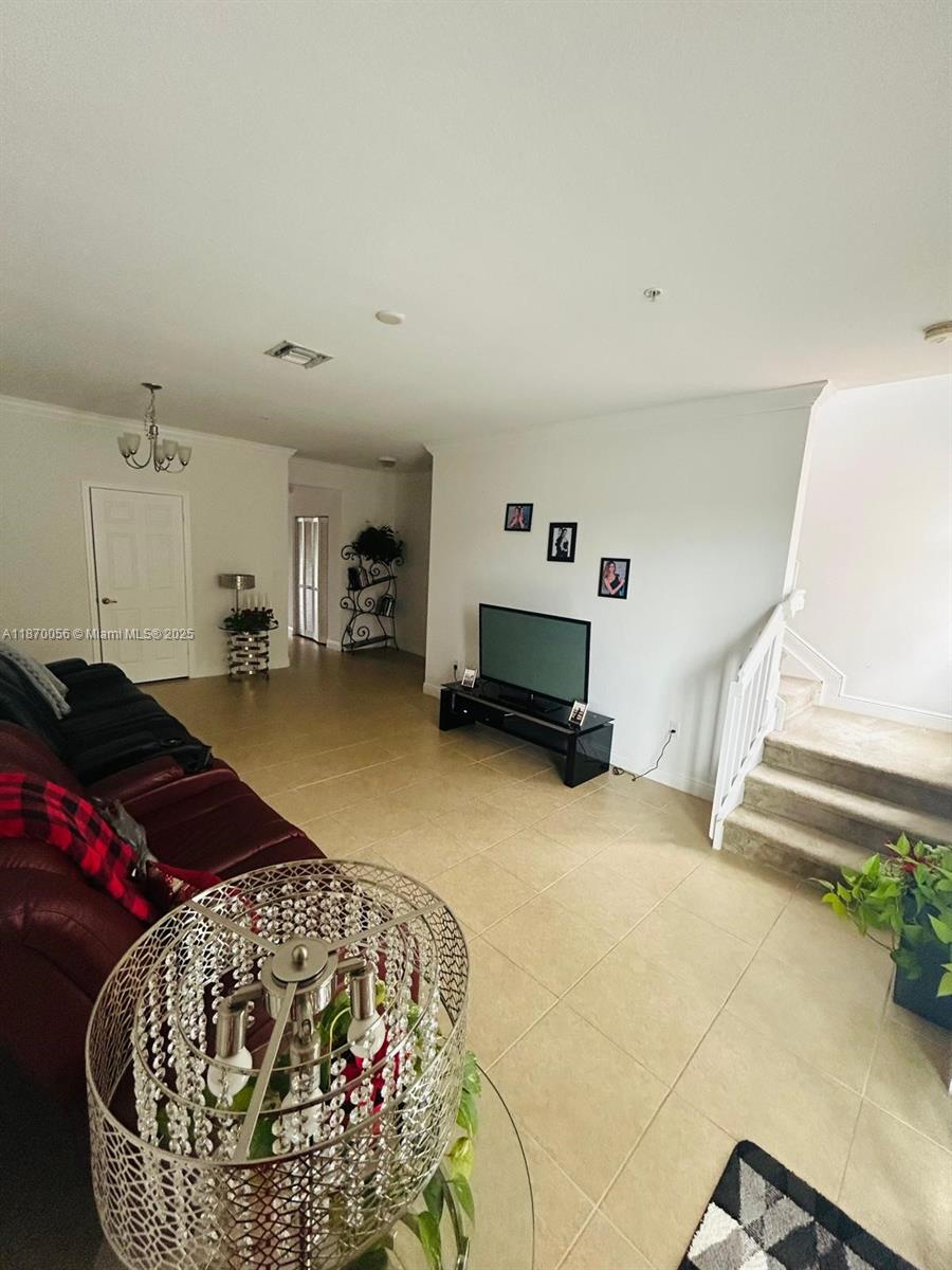 819 Southwest 147th Avenue, Unit 1405 Pembroke Pines, FL 33027 - Photo 24 of 31 a bedroom with furniture and a bed