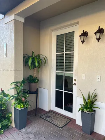 a view of a potted plant in front of a door