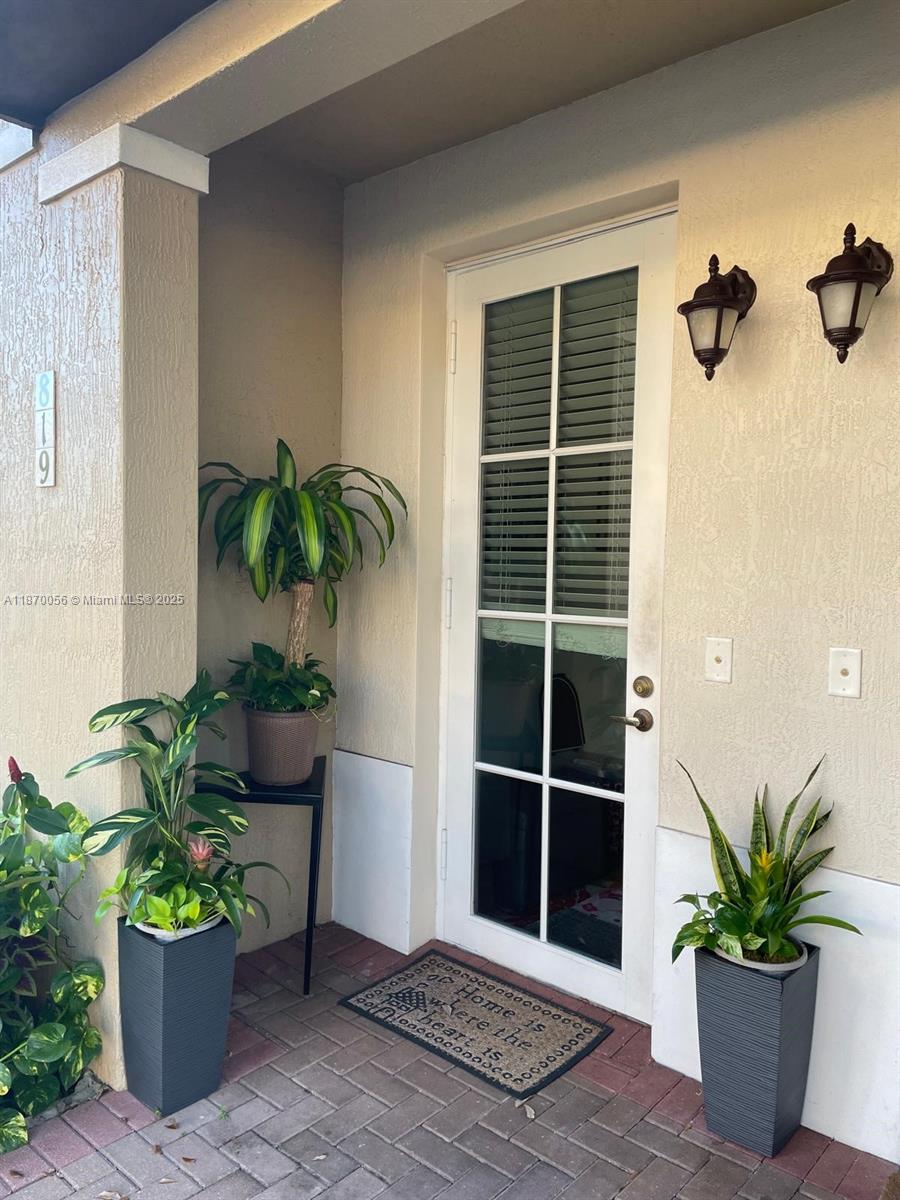 819 Southwest 147th Avenue, Unit 1405 Pembroke Pines, FL 33027 - Photo 5 of 31 a view of a potted plant in front of a door