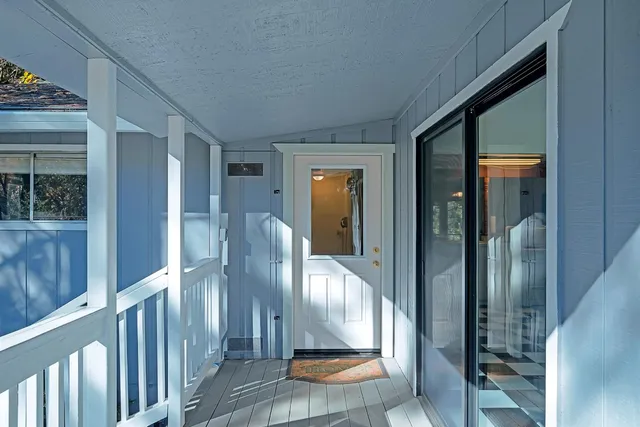 a view of an entryway door and interior of the house