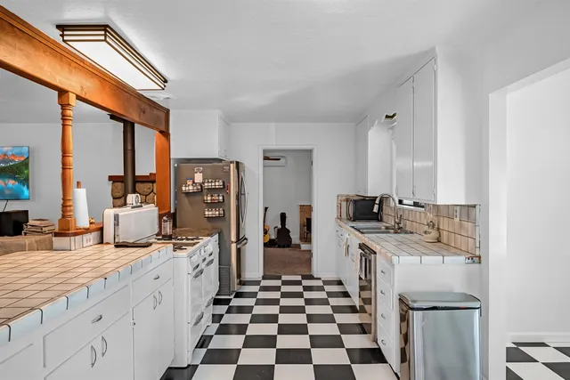a kitchen with stainless steel appliances a sink stove and refrigerator