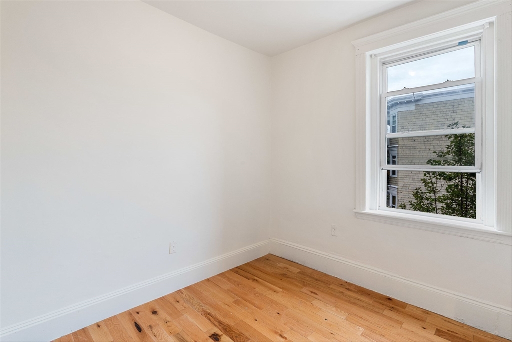 80-84 Shepton Street, Unit 803 Boston, MA 02124 - Photo 13 of 16 a view of a small space with wooden floor and a window