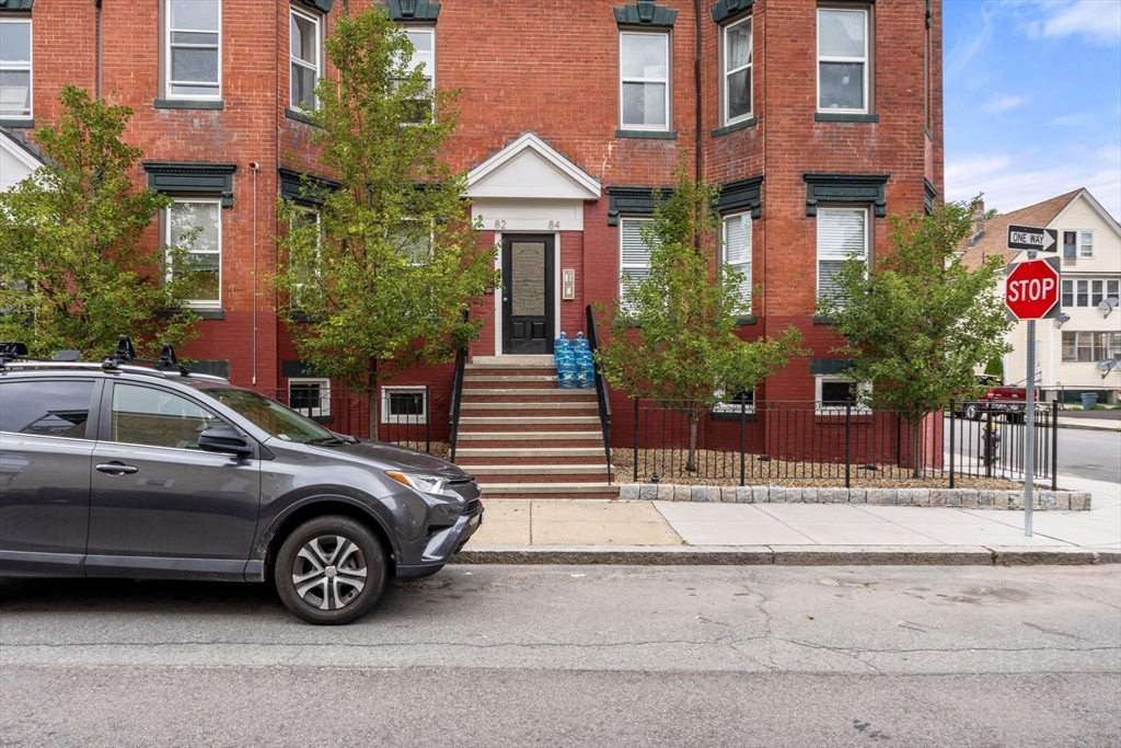 80-84 Shepton Street, Unit 803 Boston, MA 02124 - Photo 15 of 16 a view of a car parked in front of a brick house