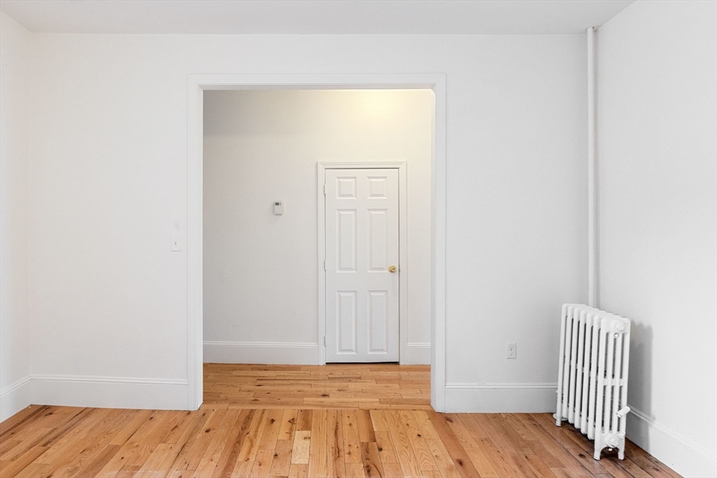 80-84 Shepton Street, Unit 803 Boston, MA 02124 - Photo 7 of 16 a view of a room with wooden floor and closet