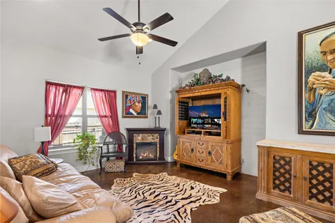 a living room with furniture a window and a fireplace