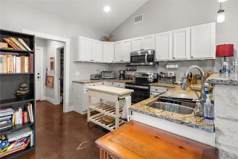 a kitchen with a sink a stove and a cabinets