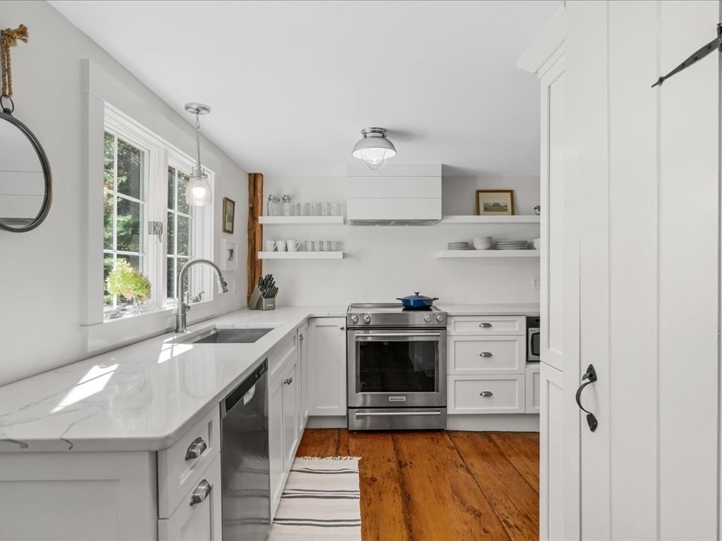 144 Old County Road Sandwich, MA 02537 - Photo 12 of 42 a kitchen with stainless steel appliances granite countertop a sink stove and refrigerator