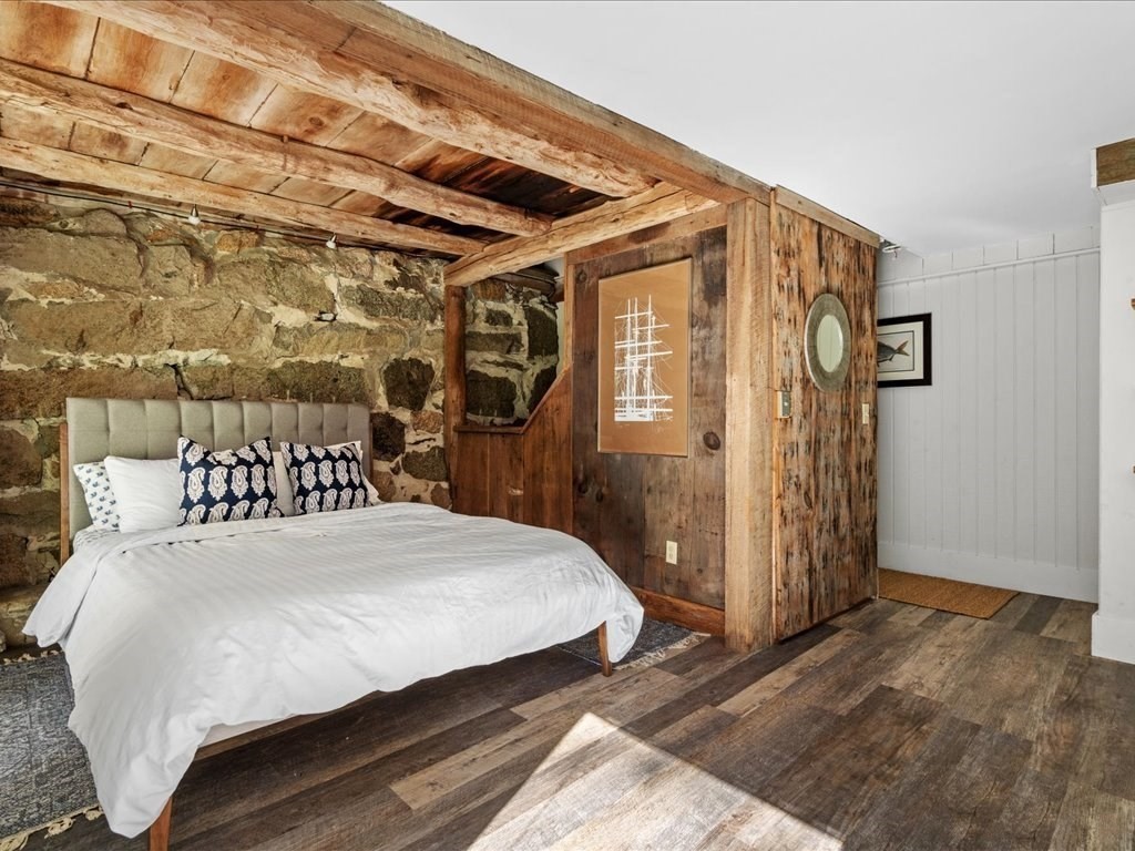 144 Old County Road Sandwich, MA 02537 - Photo 18 of 42 a bedroom with a large bed and a chandelier