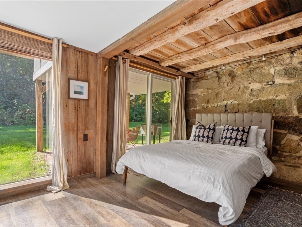 144 Old County Road Sandwich, MA 02537 - Photo 19 of 42 a bed sitting in a bedroom next to a window
