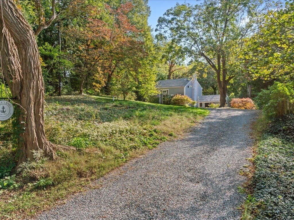 144 Old County Road Sandwich, MA 02537 - Photo 2 of 42 a view of a yard with large trees