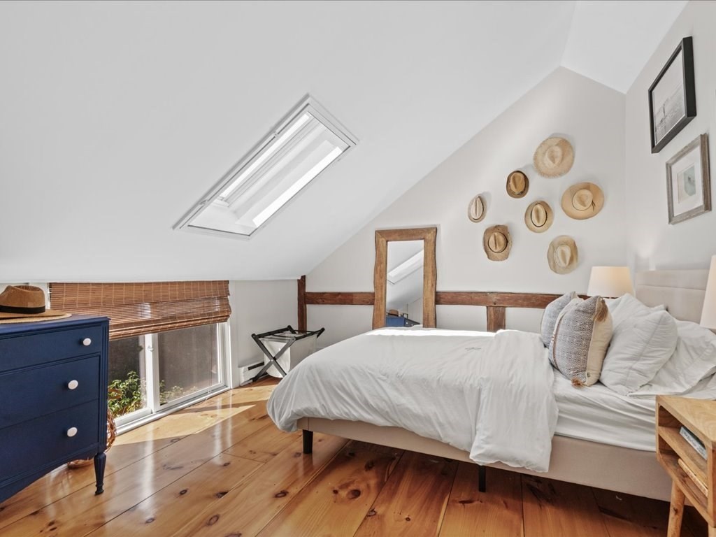 144 Old County Road Sandwich, MA 02537 - Photo 24 of 42 a bedroom with a bed and wooden floor