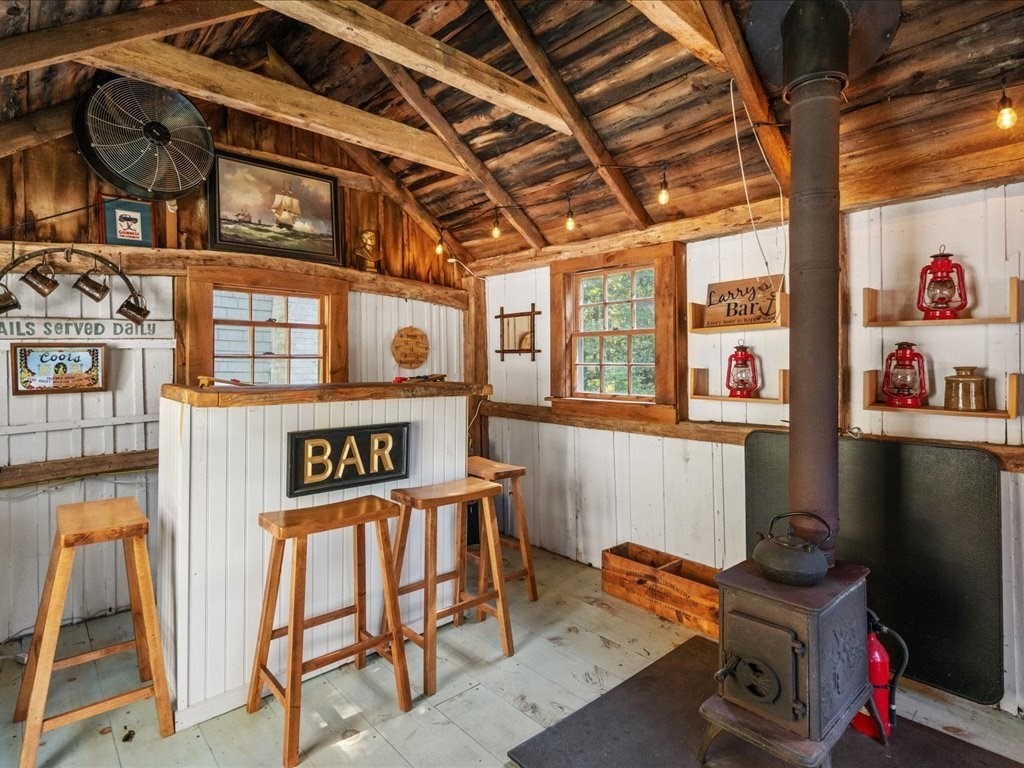144 Old County Road Sandwich, MA 02537 - Photo 30 of 42 a table and chair in a room next to a window