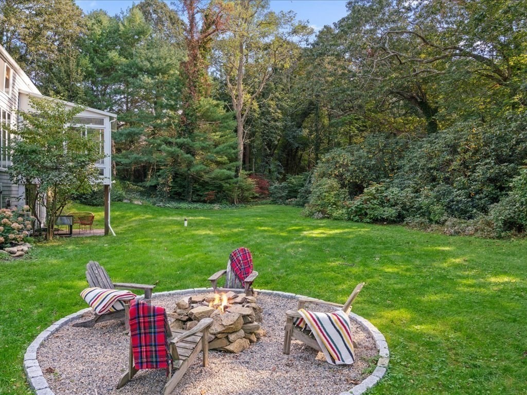 144 Old County Road Sandwich, MA 02537 - Photo 38 of 42 a view of a backyard with table and chairs with wooden fence