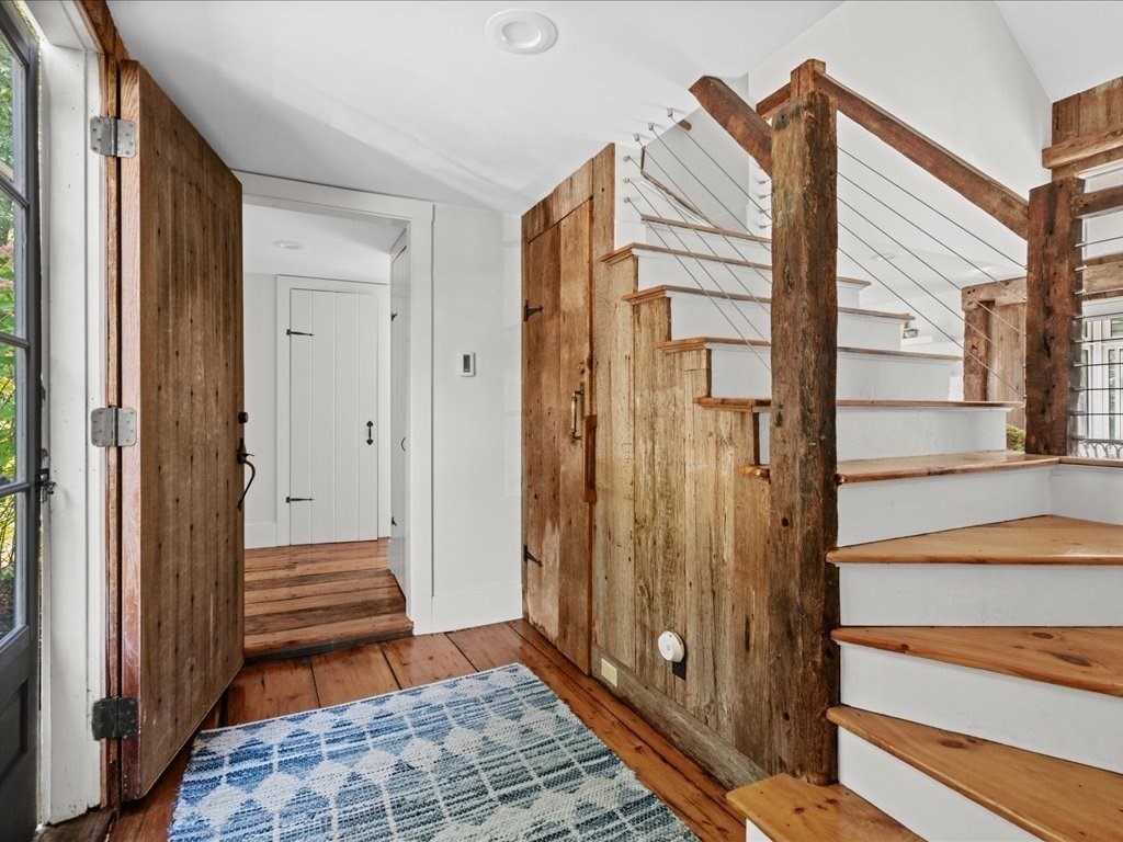 144 Old County Road Sandwich, MA 02537 - Photo 4 of 42 a view of a hallway with wooden floor and a bathroom