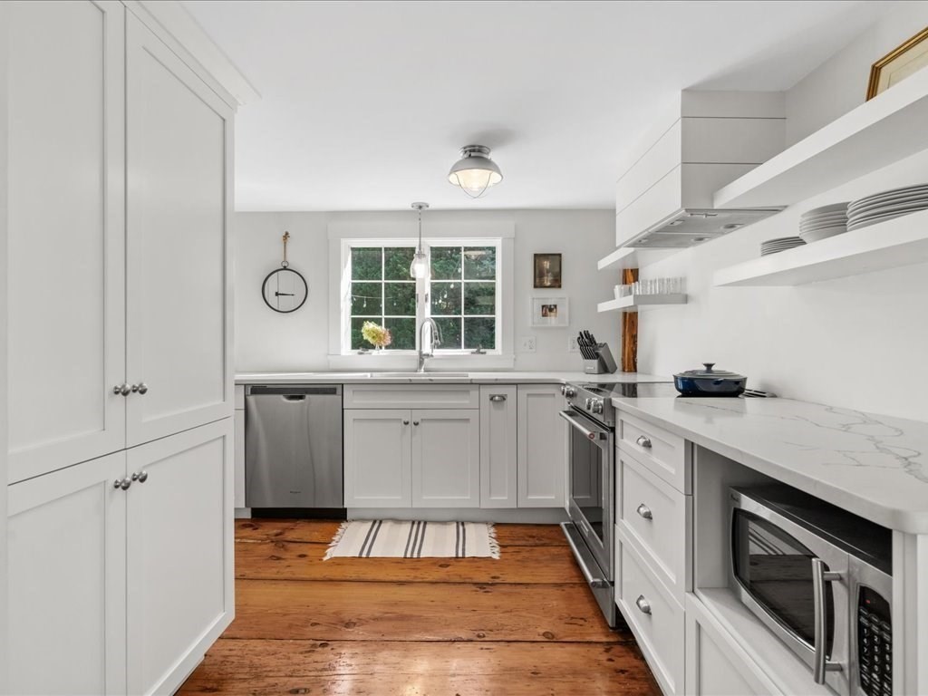 144 Old County Road Sandwich, MA 02537 - Photo 8 of 42 a kitchen with a stove sink and cabinets