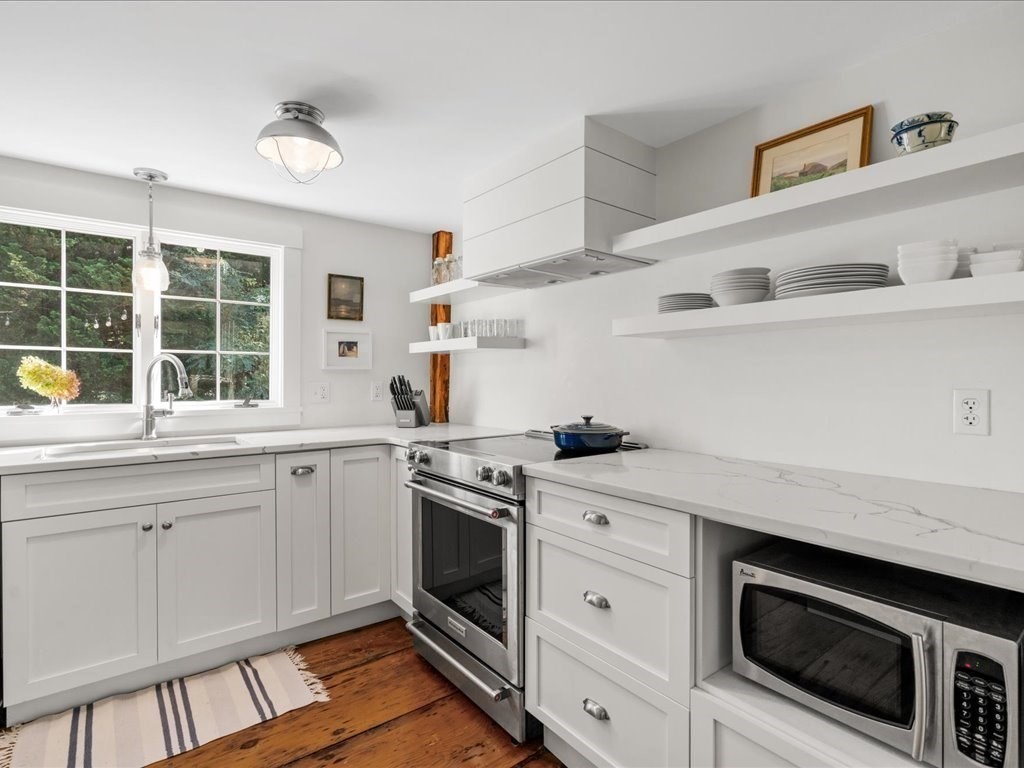 144 Old County Road Sandwich, MA 02537 - Photo 9 of 42 a kitchen with stainless steel appliances granite countertop a stove and a sink
