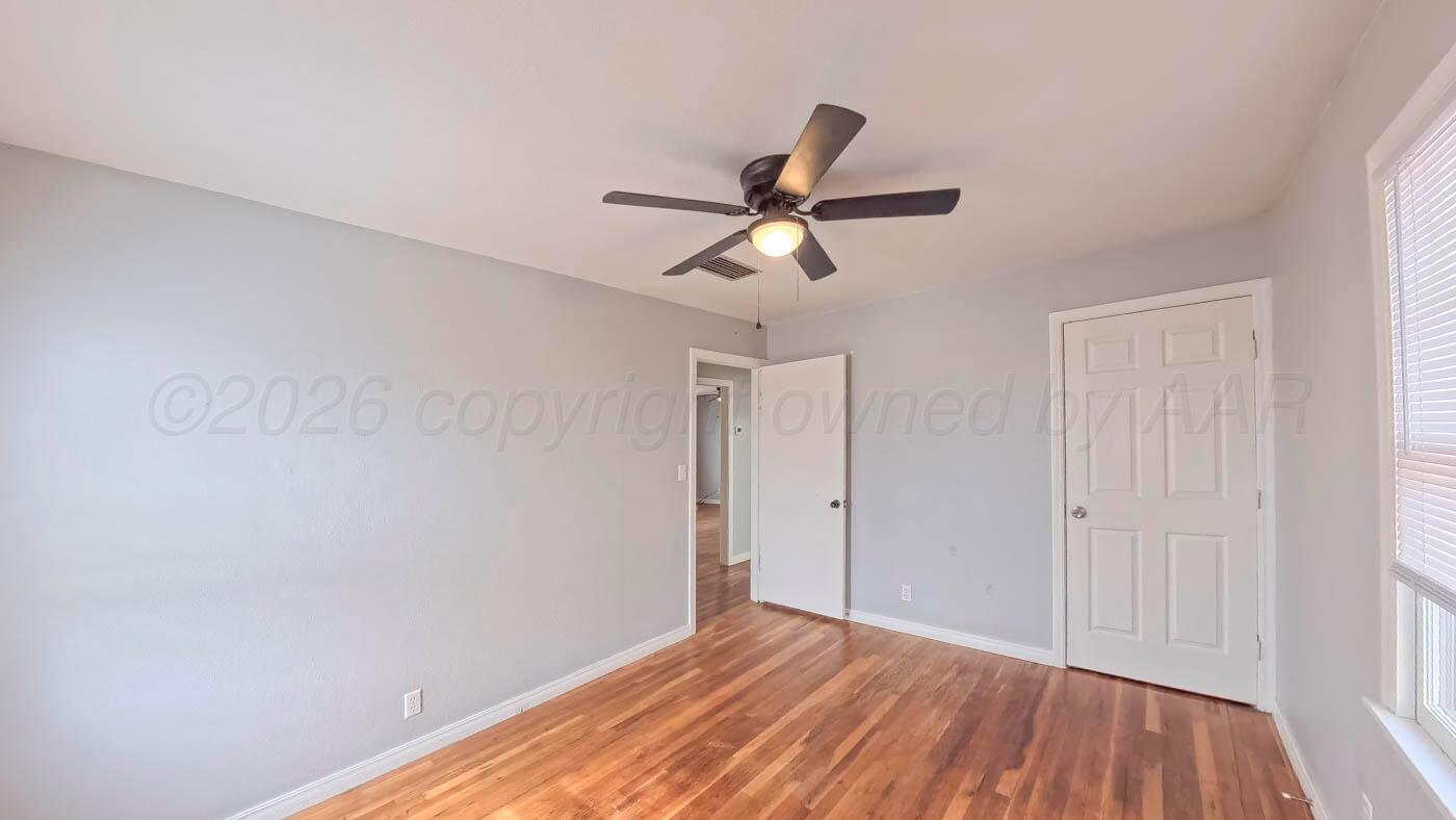 300 North Bryan Street Borger, TX 79007 - Photo 12 of 21 a view of a room with a ceiling fan and wooden floor