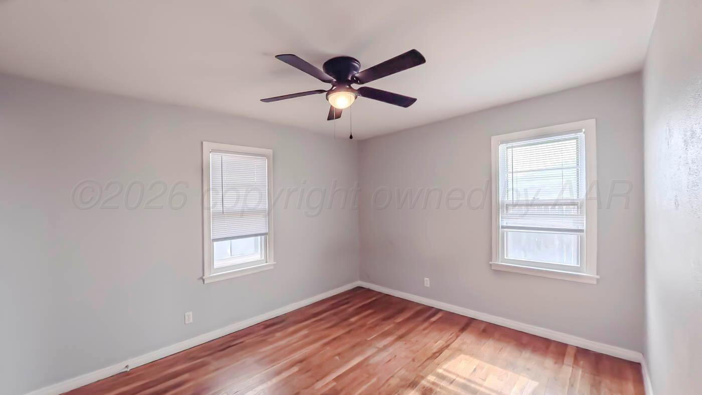 300 North Bryan Street Borger, TX 79007 - Photo 13 of 21 a view of empty room with wooden floor and fan