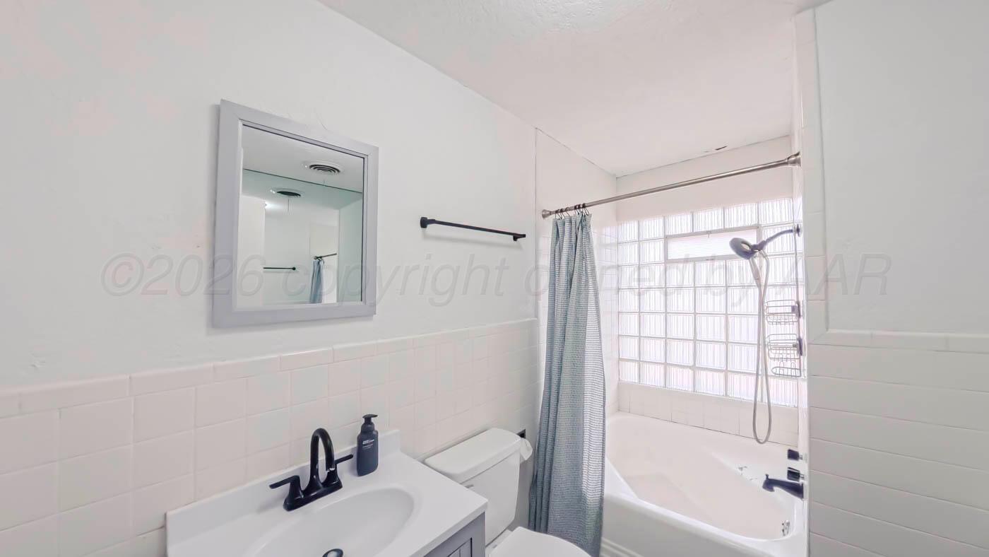 300 North Bryan Street Borger, TX 79007 - Photo 14 of 21 a bathroom with a sink toilet and shower