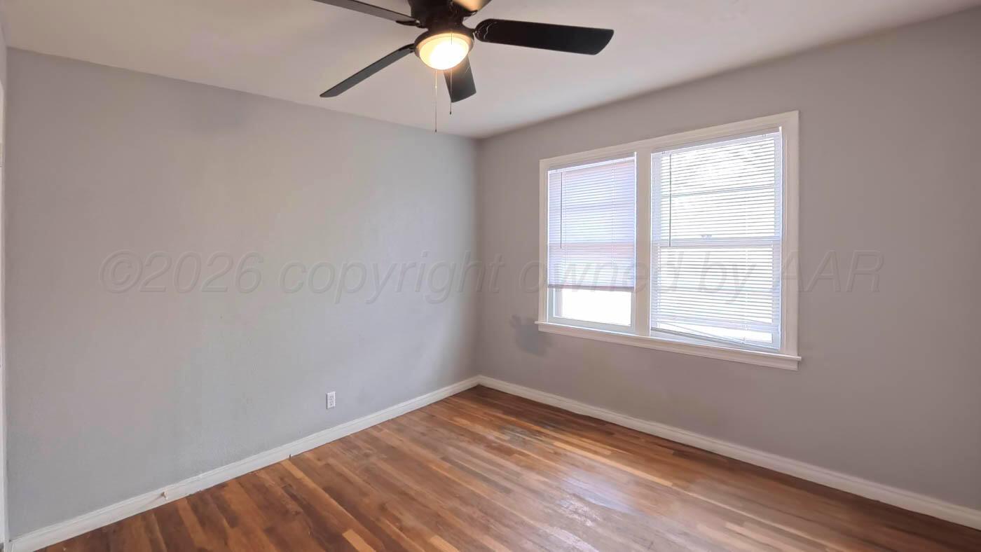 300 North Bryan Street Borger, TX 79007 - Photo 15 of 21 an empty room with a window and a fan