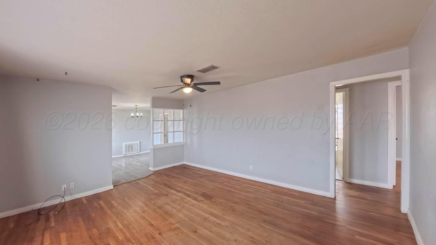300 North Bryan Street Borger, TX 79007 - Photo 16 of 21 wooden floor in an empty room with a window