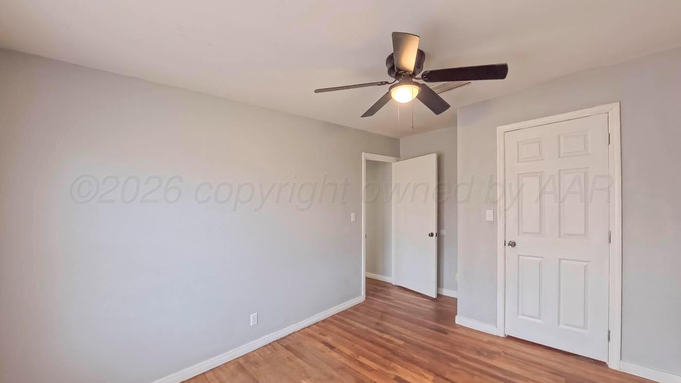 300 North Bryan Street Borger, TX 79007 - Photo 10 of 21 a view of empty room with wooden floor and fan