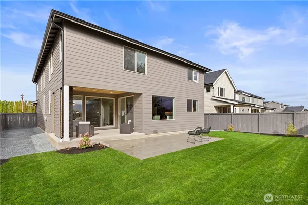 a view of a house with a yard and sitting area