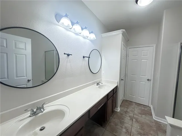 a bathroom with a double vanity sink mirror and double