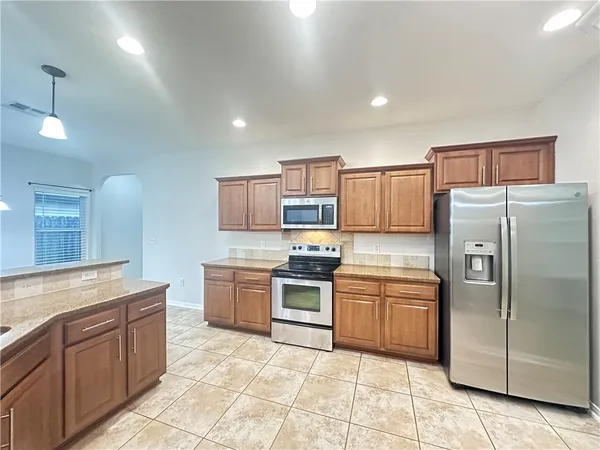 a kitchen with cabinets and stainless steel appliances