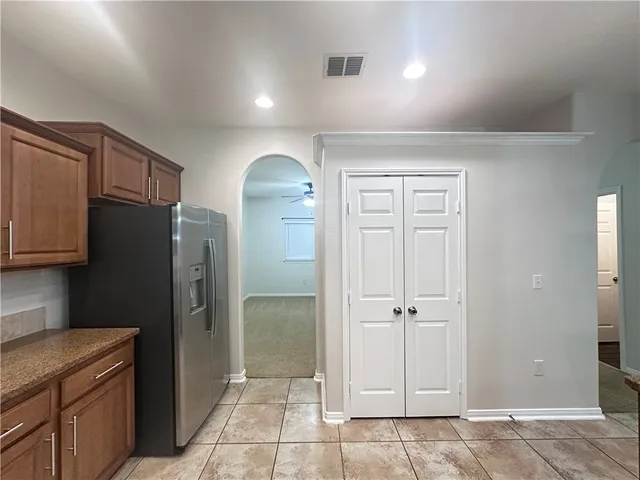 a view of a kitchen with refrigerator cabinets and wooden floor