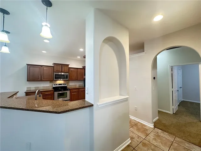 a kitchen with stainless steel appliances a refrigerator and microwave