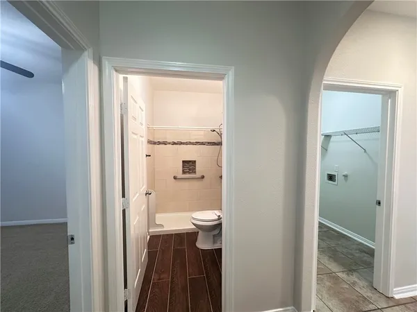 a bathroom with a granite countertop toilet a sink and a shower