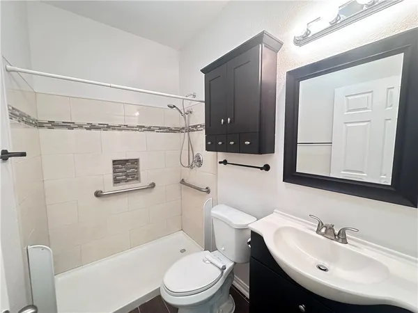 a bathroom with a sink a mirror and a toilet