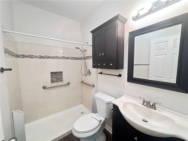 a bathroom with a sink a mirror and a toilet