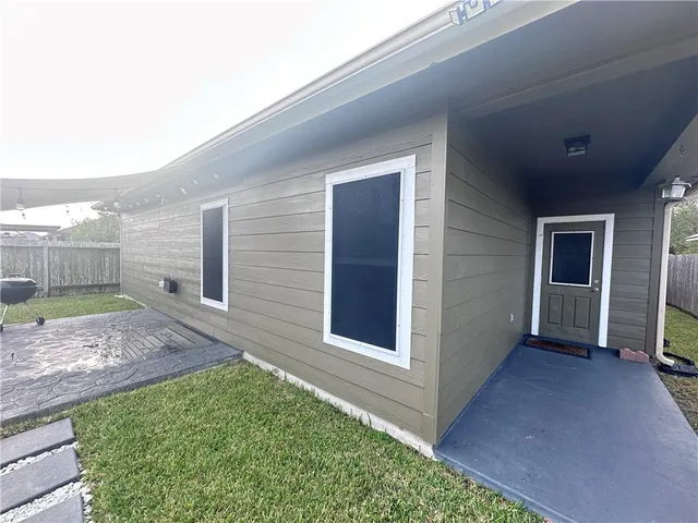a view of front door and yard