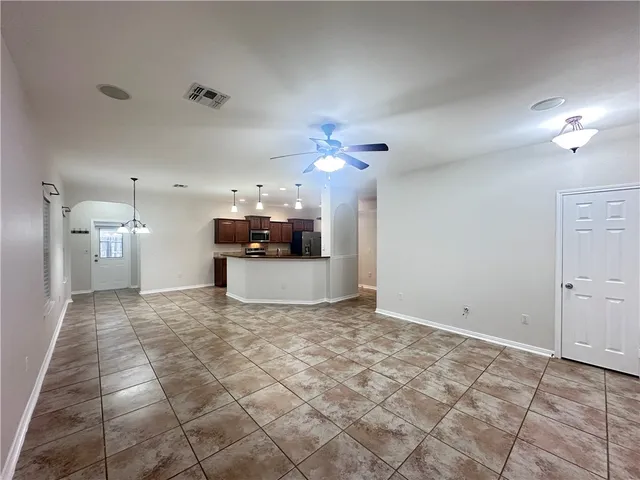 a view of a kitchen with a sink and a refrigerator