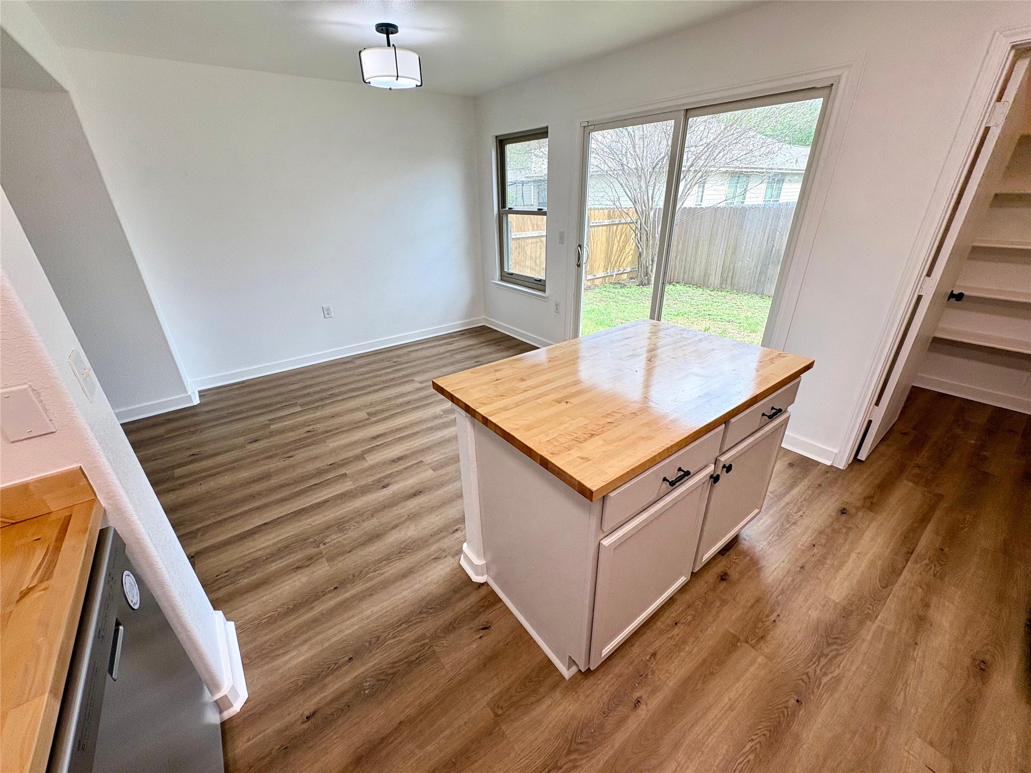 8003 Bannock Lane Austin, TX 78747 - Photo 13 of 40 Dining space with dark wood-style flooring and baseboards