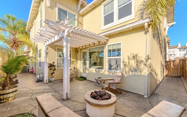 a view of a patio with couches fire pit and outdoor seating