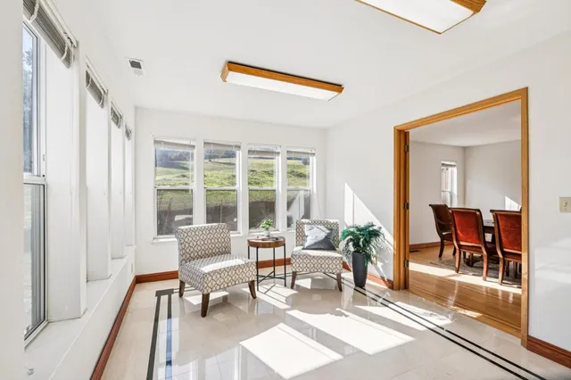 a view of a kitchen with refrigerator and wooden floor