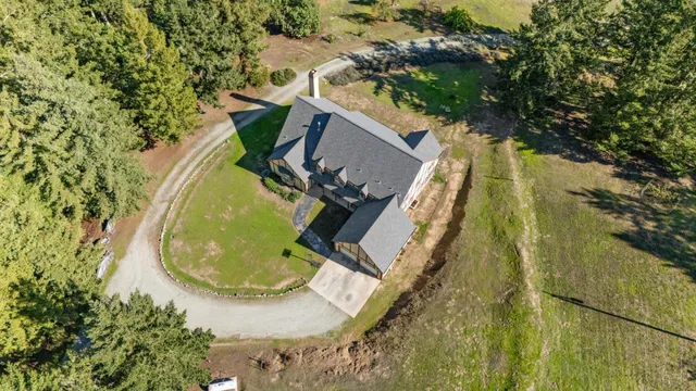 a view of a house with a tree in front of it