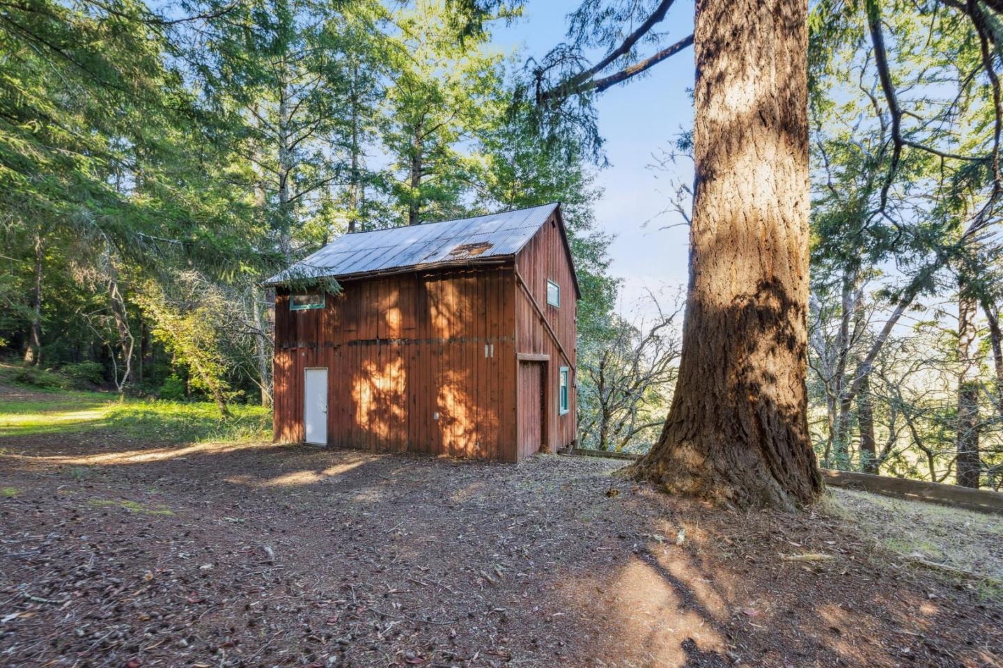 24595 Skyland Road Los Gatos, CA 95033 - Photo 53 of 68 a view of a house with large trees and a small yard