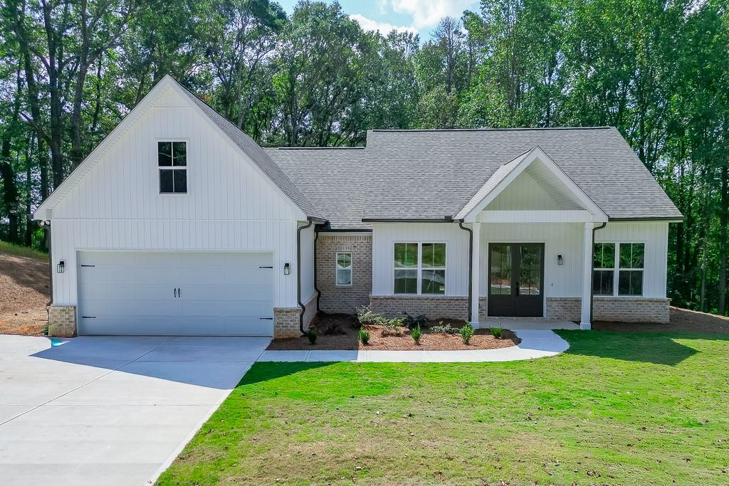 a front view of house with yard outdoor seating and green space